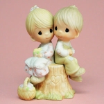 "Love One Another" is a typical example of a Precious Moments porcelain figurine